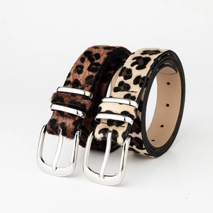 Detail of leopard print faux fur belts with silver metal buckles in brown and beige