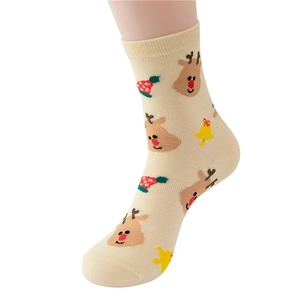 Christmas cotton socks with cartoon reindeer and bells on beige background