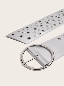 Close-up of silver PU leather belt with metal studs and a large circular buckle