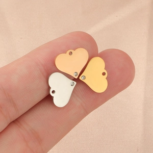 Three mirror-polished steel heart charms with crystals in rose gold, gold, and silver