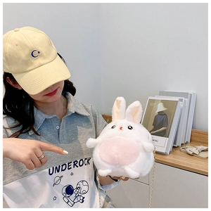 Detailed view of white plush rabbit crossbody bag featuring a stylish golden chain strap