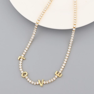 Macro shot of 18K gold plated LOVE tennis necklace with sparkling cubic zirconia crystals