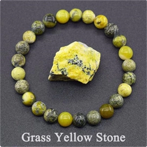 Detail view of 8mm yellow stone beaded elastic bracelet with a matching raw gemstone piece
