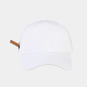 Detail view of white cotton baseball cap showing brown leather patch and fine stitching