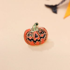 Detail of Halloween pumpkin brooch with sparkling orange rhinestones and enamel finish