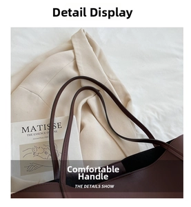 Detailed close-up of dark brown leather tote handles with clean edges and smooth texture
