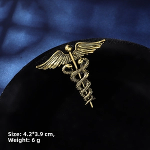 Detailed view of vintage gold Caduceus snake brooch showing 4.2x3.9cm dimensions