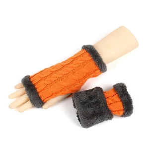 Detail of orange cable knit fingerless gloves with grey faux fur trim on white background