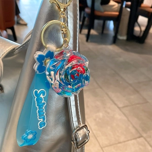 Blue liquid oil rose flower keychain with Sakura silicone strap on silver bag accessory