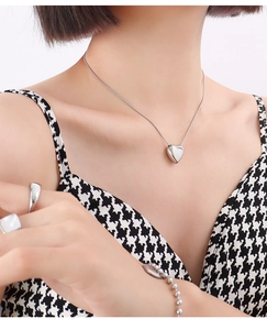 Silver heart pendant necklace with matching ring and bead bracelet on model
