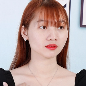 Gros plan sur le collier à pendentif feuille argenté et boucles d'oreilles assorties sur modèle