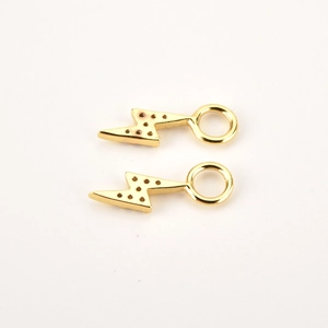 Close-up of elegant gold plated sterling silver lightning bolt charms on white background