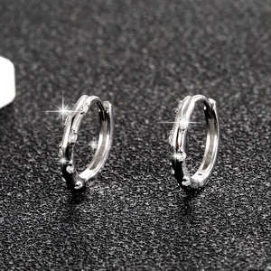 Macro shot of S925 sterling silver hoop earrings with sparkling cubic zirconia inlay