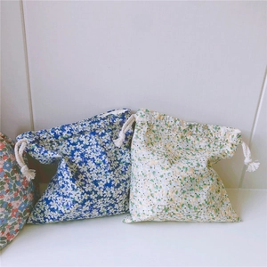 Detail of floral cotton drawstring pouches with blue and yellow flower patterns