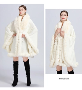 Macro detail of luxurious white faux rabbit fur trim on an elegant knitted winter cape