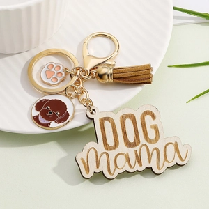 Detail of wooden Dog Mama keychain with colorful tassel and brown poodle enamel charm