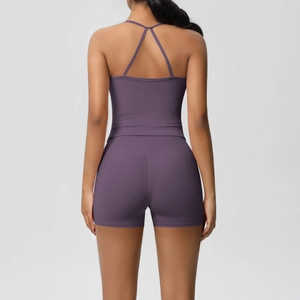 Detail view of purple yoga set featuring criss-cross back straps and high-waist biker shorts