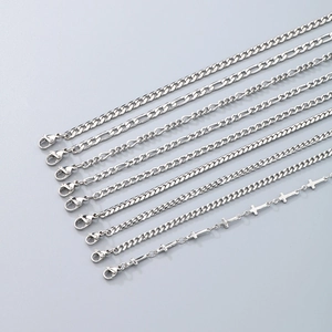 Detail of eight silver titanium steel NK chain styles with lobster clasps and flat links