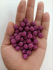 Detailed view of magenta disco beads with full crystal pave on a white background
