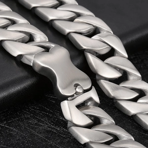 Macro shot of silver matte Cuban chain link with unique bone-shaped clasp detail