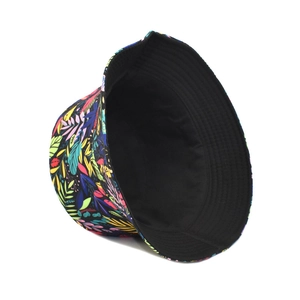 Detail of double-sided bucket hat featuring tropical floral print on black background