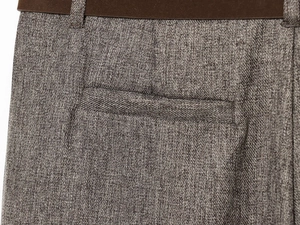 Macro detail of herringbone twill pants showing waistband, belt loops and rear pocket