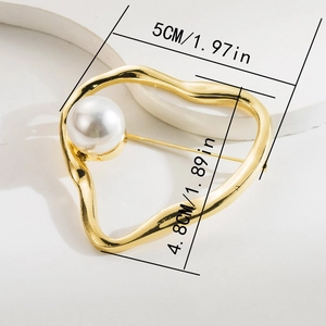 Detailed view of a gold heart brooch with large pearl inlay showing size 5cm by 4.8cm