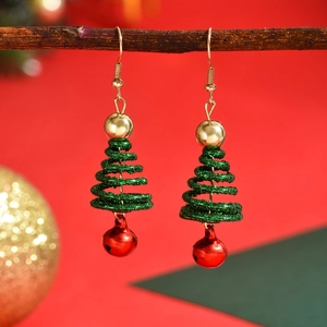 Sparkly green Christmas tree earrings with golden beads and red bells on festive branch