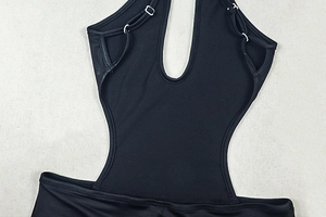 Detail of black cut-out bodysuit featuring thin straps and silver metal adjustment buckles