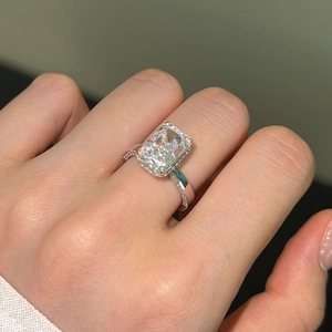 Close-up of S925 silver ring with rectangular ice-cut zircon and side diamonds on finger