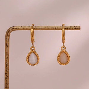 Detail of teardrop cat eye stone earrings with vintage gold textured metal plating