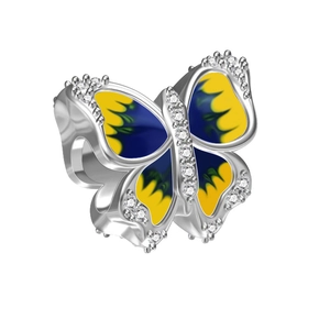 Macro shot of silver butterfly charm with yellow-blue enamel and sparkling zircon