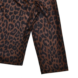 Close-up detail of soft leopard print fabric texture and pattern on long sleeve top