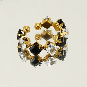 Detail of adjustable gold ring featuring square black and white cubic zirconia stones