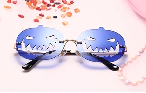 Blue pumpkin-shaped rimless sunglasses with gold metal temples on pink background