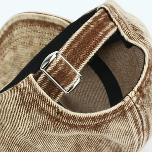 Detail of vintage denim baseball cap with adjustable metal buckle and neat stitching