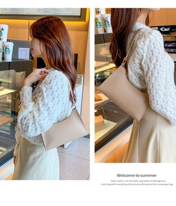 Detailed views of a cream minimalist underarm bag shown in a cozy cafe setting