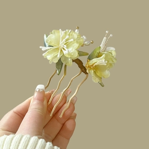 Detail of handcrafted green peony hair comb with delicate wire wrapping and pearls
