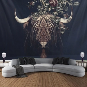 Detail of floral Highland Cow tapestry hanging over a modern sofa in a cozy living room