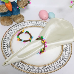 Detailed view of Easter napkin ring with colorful berry beads on woven rattan ring