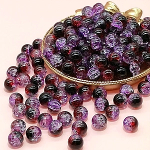 Macro detail of 10mm cracked glass beads in dark purple for DIY jewelry making