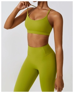 Close-up of grass green high-waist yoga set with slim straps and matte elastic fabric