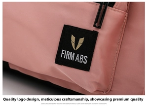 Detail of water-resistant pink nylon fabric and FIRM ABS logo embroidery on travel bag