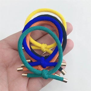 Close-up of five colorful high-elastic hair ties with stylish gold metal cylinder buckles