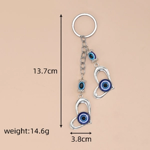 Detail view of Evil Eye heart keychain with dimensions 13.7cm length and 14.6g weight