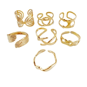Set of 7 gold geometric stainless steel rings featuring butterfly and wing wing designs