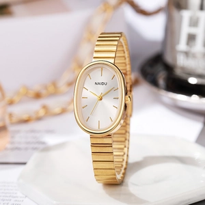 Detail of elegant gold oval dial watch with elastic metal bracelet band for women