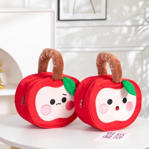 Detailed view of red apple plush bags with cute faces and Happy embroidery handles