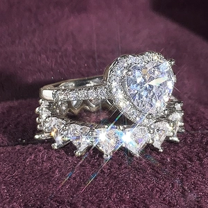 Macro view of heart-shaped zircon wedding ring set with halo pave on purple velvet