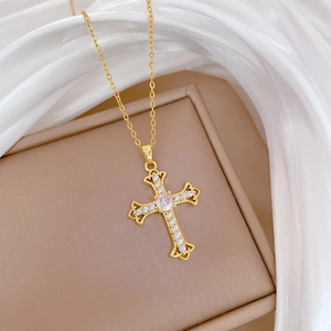 Titanium steel cross necklace with crystal pavé on beige jewelry box with silk fabric